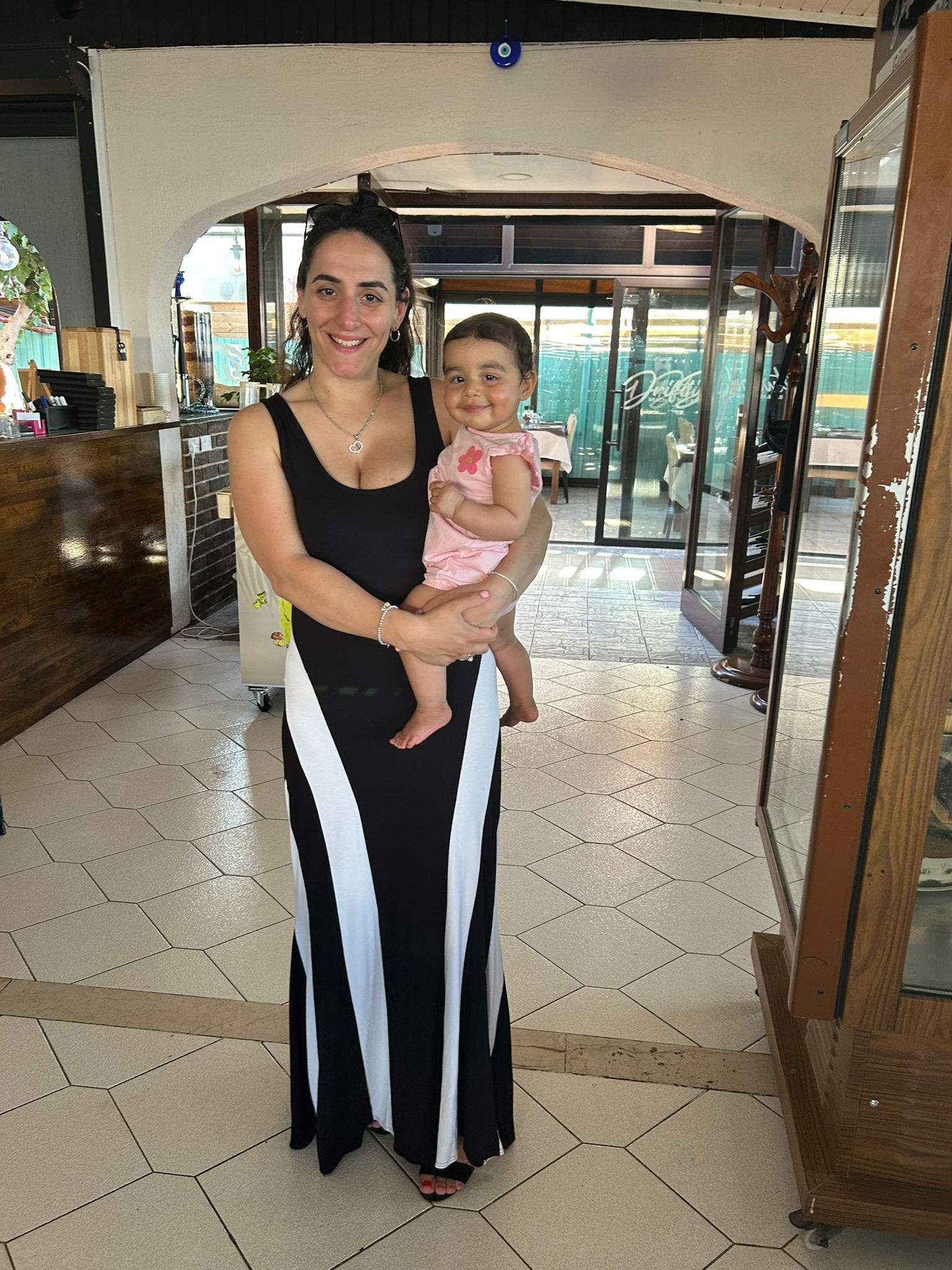 Jeyda Roach, founder of The Mum Desk, holding her baby daughter.